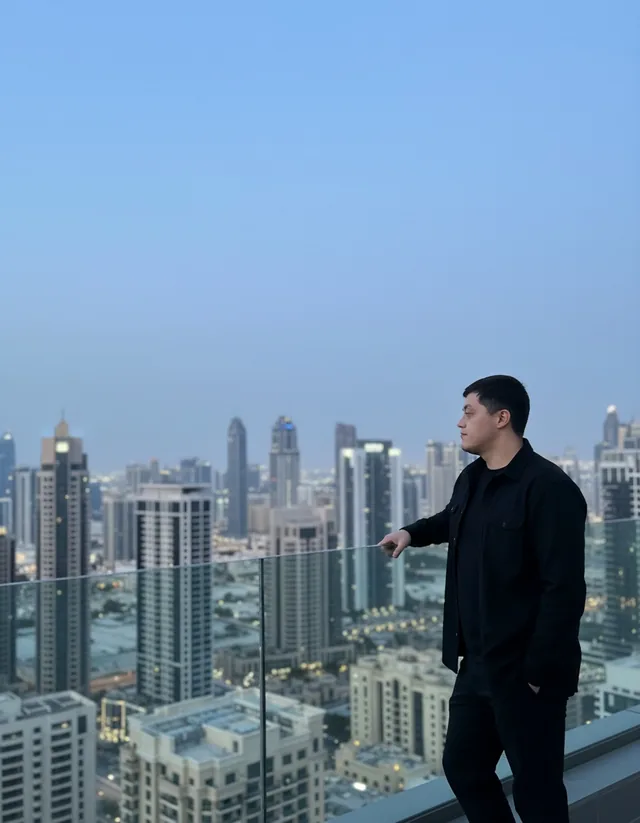 Said on a rooftop terrace in Downtown Dubai at dusk, looking out over the skyline